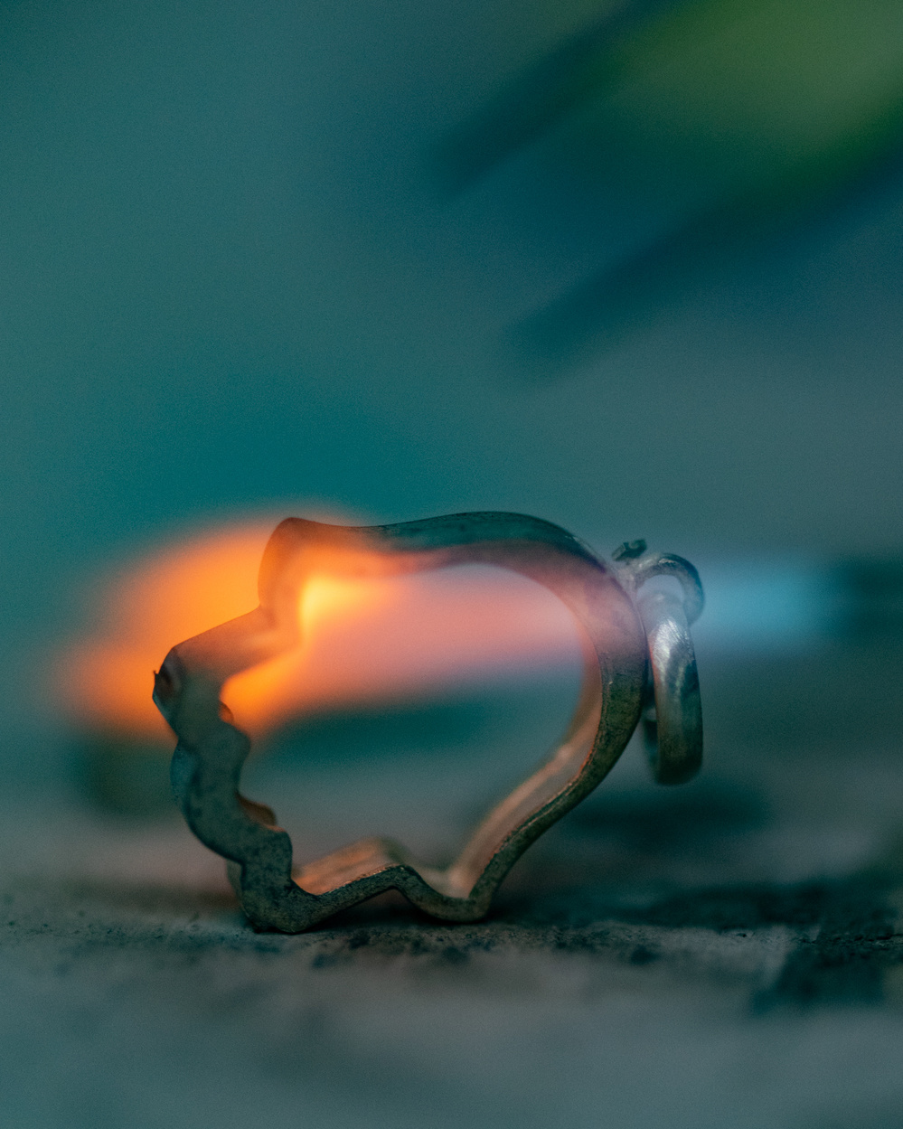 The Hamsa hand symbol being heated up by a blowtorch.