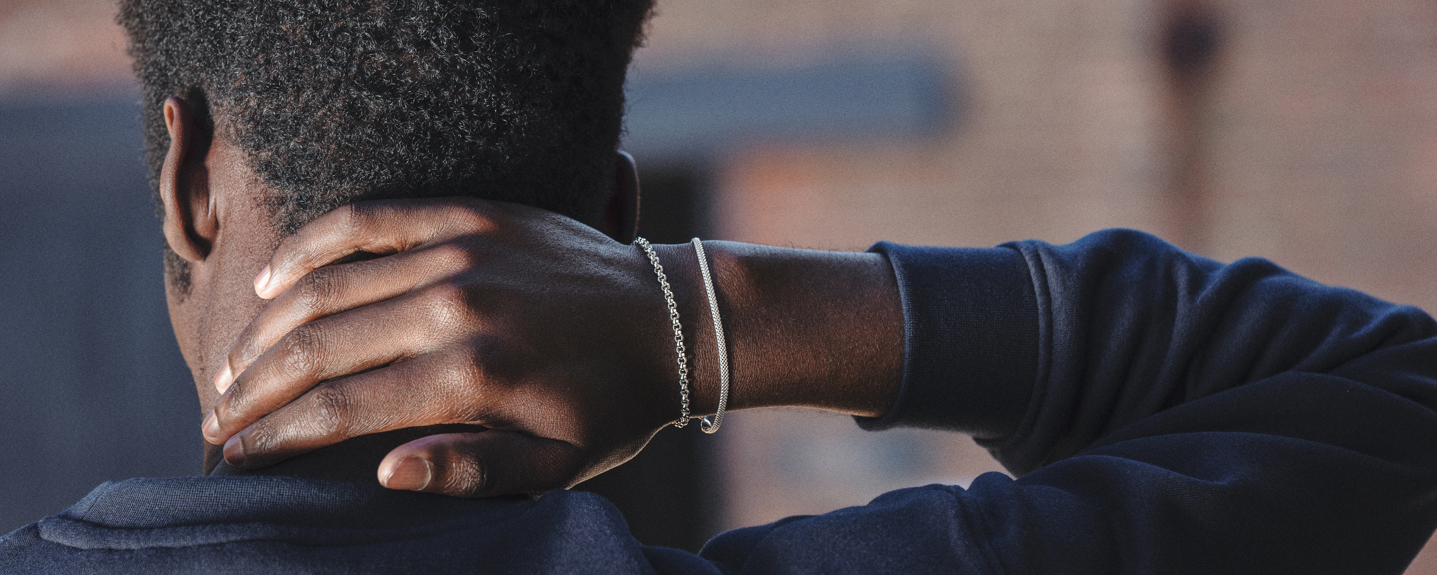 Silver chain bracelets worn on model